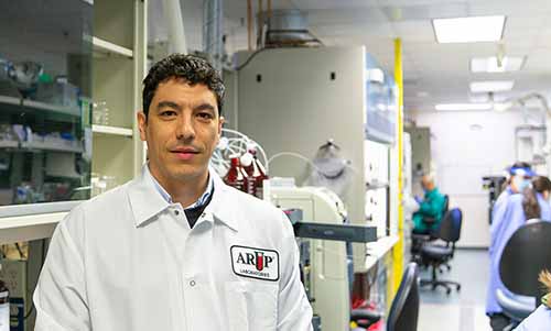 Filippo Ingoglia stands in a research laboratory